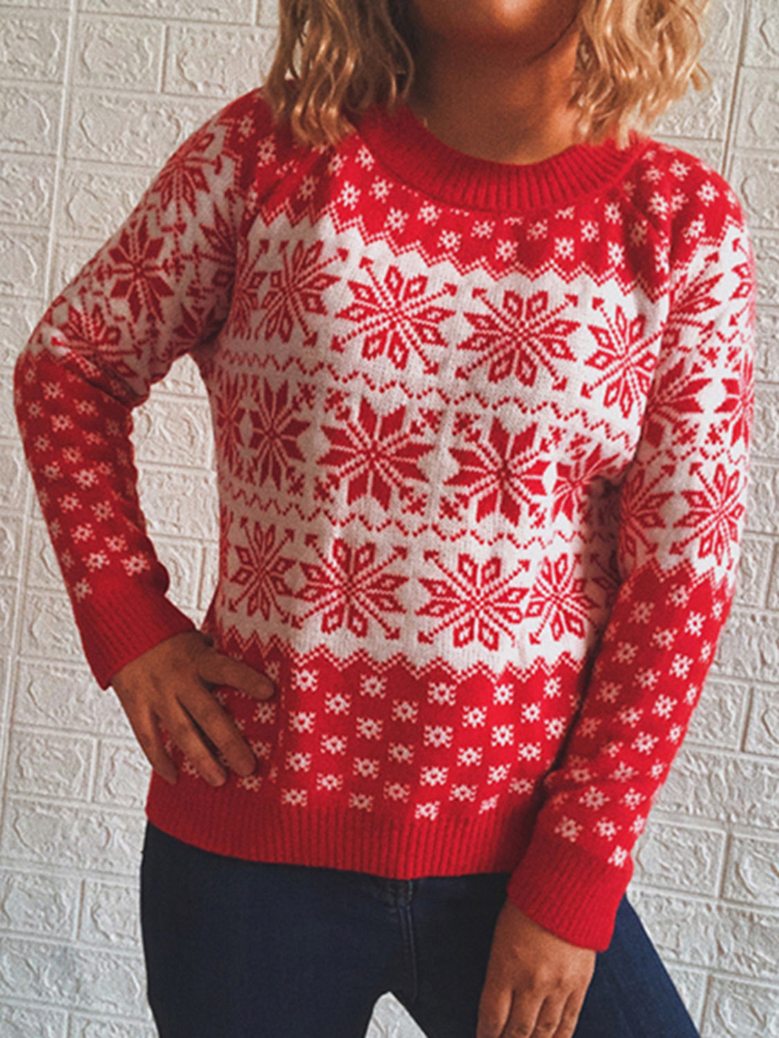 Red and white snowflake knit pullover sweater with crew neck and long sleeves.
