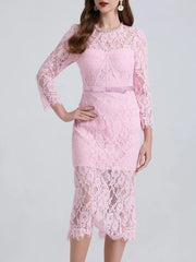 Pink lace midi dress with sheer sleeves and a pink bow belt.