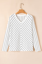 White chevron stripe v-neck relaxed fit blouse with long sleeves.