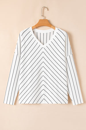 White chevron stripe v-neck relaxed fit blouse with long sleeves.