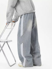 Relaxed fit wide-leg jeans in Vintage Blue with white striped detail and drawstring waist.