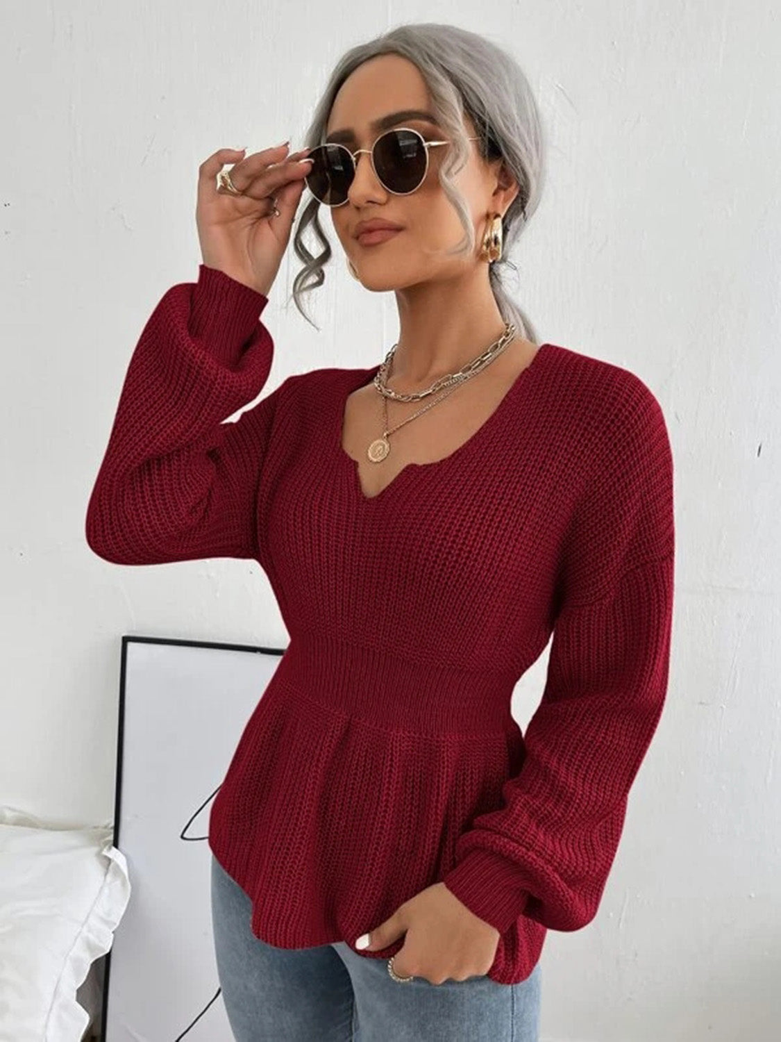 Wine peplum knit sweater with scallop neckline and balloon sleeves.
