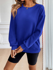 Relaxed fit royal blue sweatshirt with crewneck and ribbed cuffs.