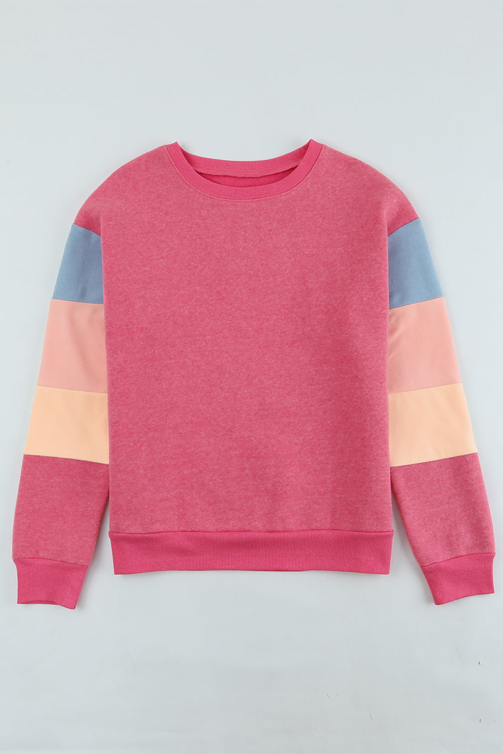 Colorblock sweatshirt with crewneck and long sleeves in pink, peach, and blue panels.