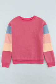 Colorblock sweatshirt with crewneck and long sleeves in pink, peach, and blue panels.