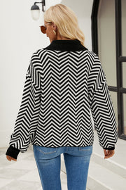 Chevron knit polo sweater in black and white acrylic with a buttoned collar.