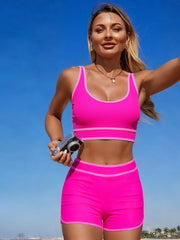 Fuchsia pink two-piece swimwear with contrast trim, scoop neck top and high-waisted shorts.