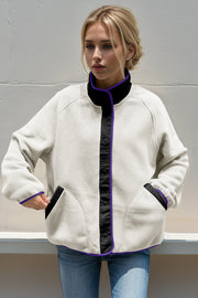 Light gray fleece bomber jacket with black and purple contrast trim and snap front.