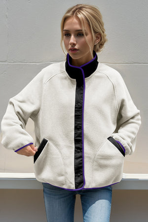 Light gray fleece bomber jacket with black and purple contrast trim and snap front.