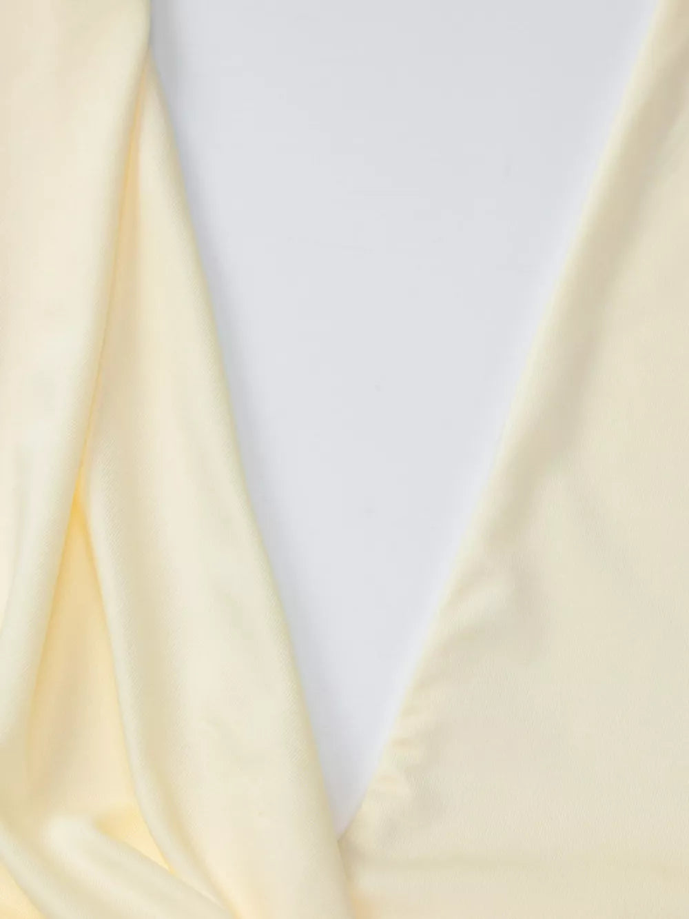 Yellow ruched halter neck maxi dress detail showing fabric drape