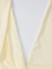 Yellow ruched halter neck maxi dress detail showing fabric drape