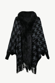 Houndstooth faux fur collar poncho in black and grey with fringe detail.