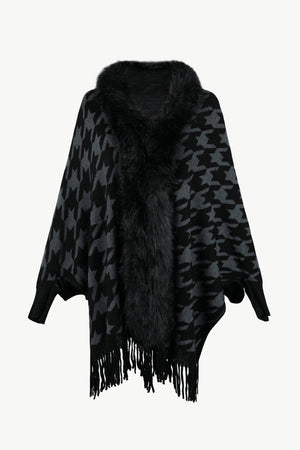 Houndstooth faux fur collar poncho in black and grey with fringe detail.