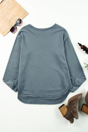 Dull blue sweatshirt with asymmetric hemline and raw edge detail.