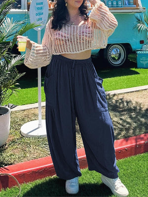 Navy linen balloon trousers with cargo pockets and drawstring waist.