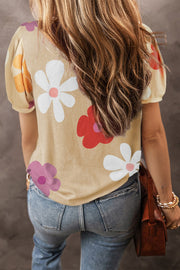 Tan puff sleeve t-shirt with large floral print and short sleeves.