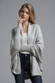 Gray acrylic batwing cardigan with textured sleeves and drape front.