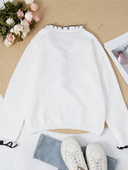 White acrylic knit sweater with ruffled V-neck and cuffs.