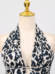 Halter neck leopard print mini dress with a deep V-neck and cutout detail.