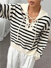 Black and white striped long-sleeve sweater with lace-up neckline detail.