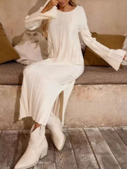 White ribbed knit maxi sweater dress with crew neck, bell sleeves, and side slit.
