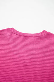 Hot Pink waffle knit V-neck t-shirt with textured polyester fabric.
