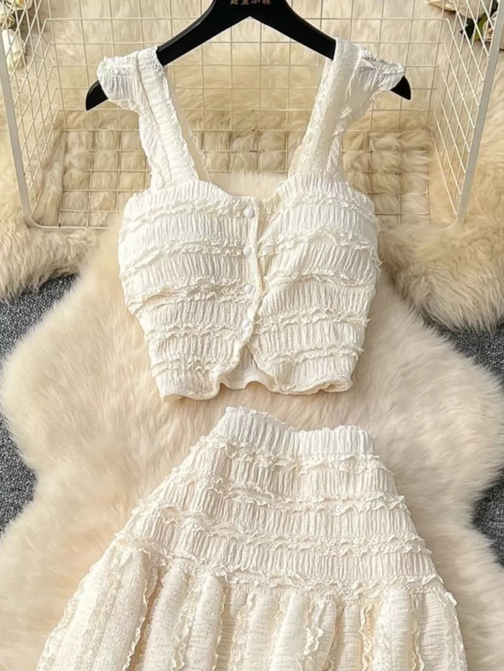 White textured two-piece set with ruffled details and buttoned crop top with frill sleeves.