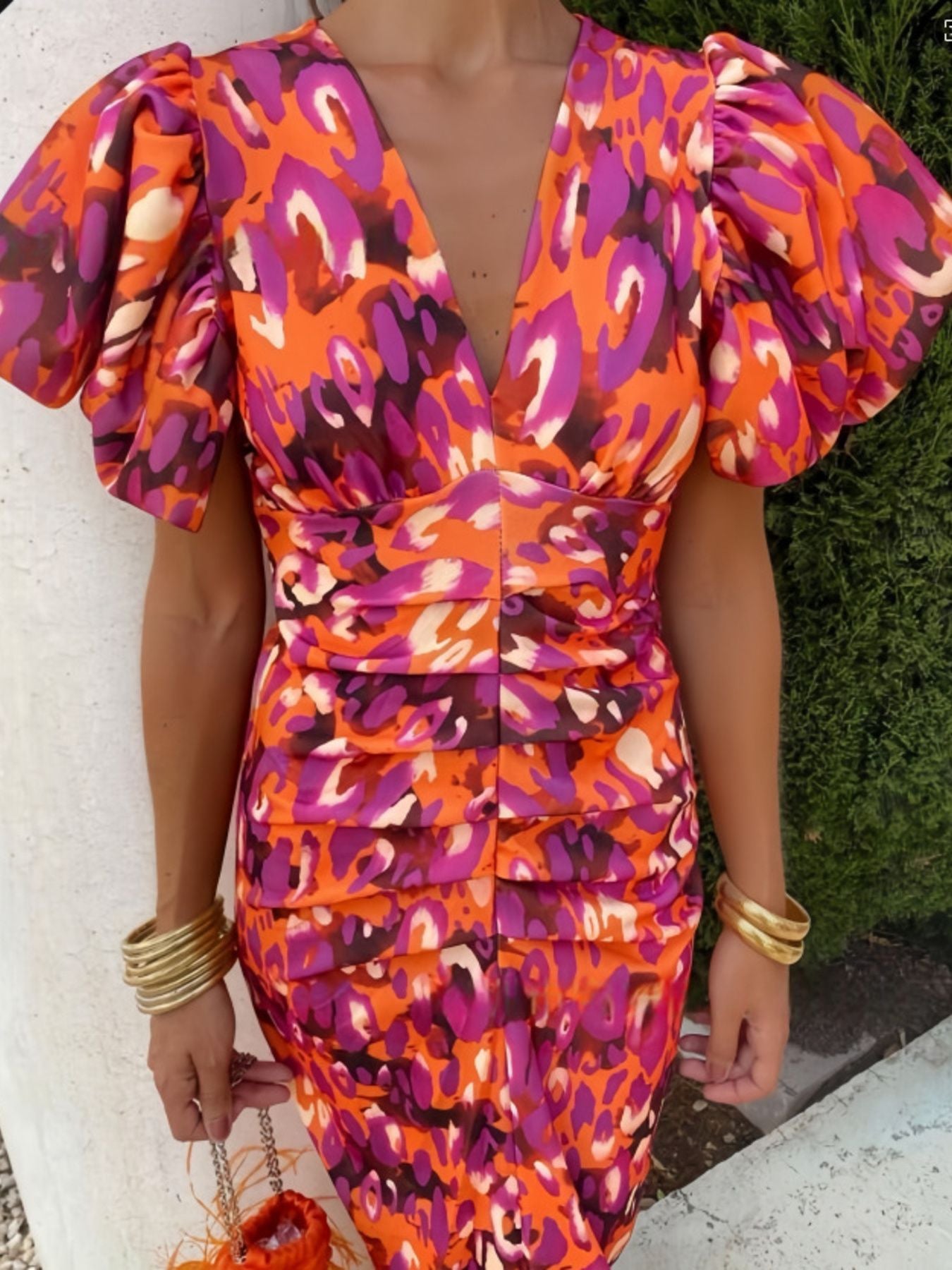 Vibrant orange red midi dress with abstract print, V-neck, and puff sleeves.