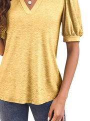 Yellow puff sleeve t-shirt with notched V-neck and textured fabric.