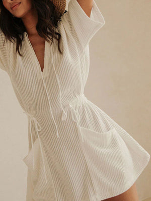 White textured half sleeve cover-up dress with drawstring waist and pockets.