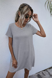 Light gray relaxed t-shirt dress with short sleeves and crew neck.