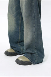 Faded wash wide-leg jeans in medium blue denim with a relaxed fit.