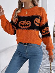Orange acrylic knit sweater with jack-o'-lantern intarsia pattern and crew neck.