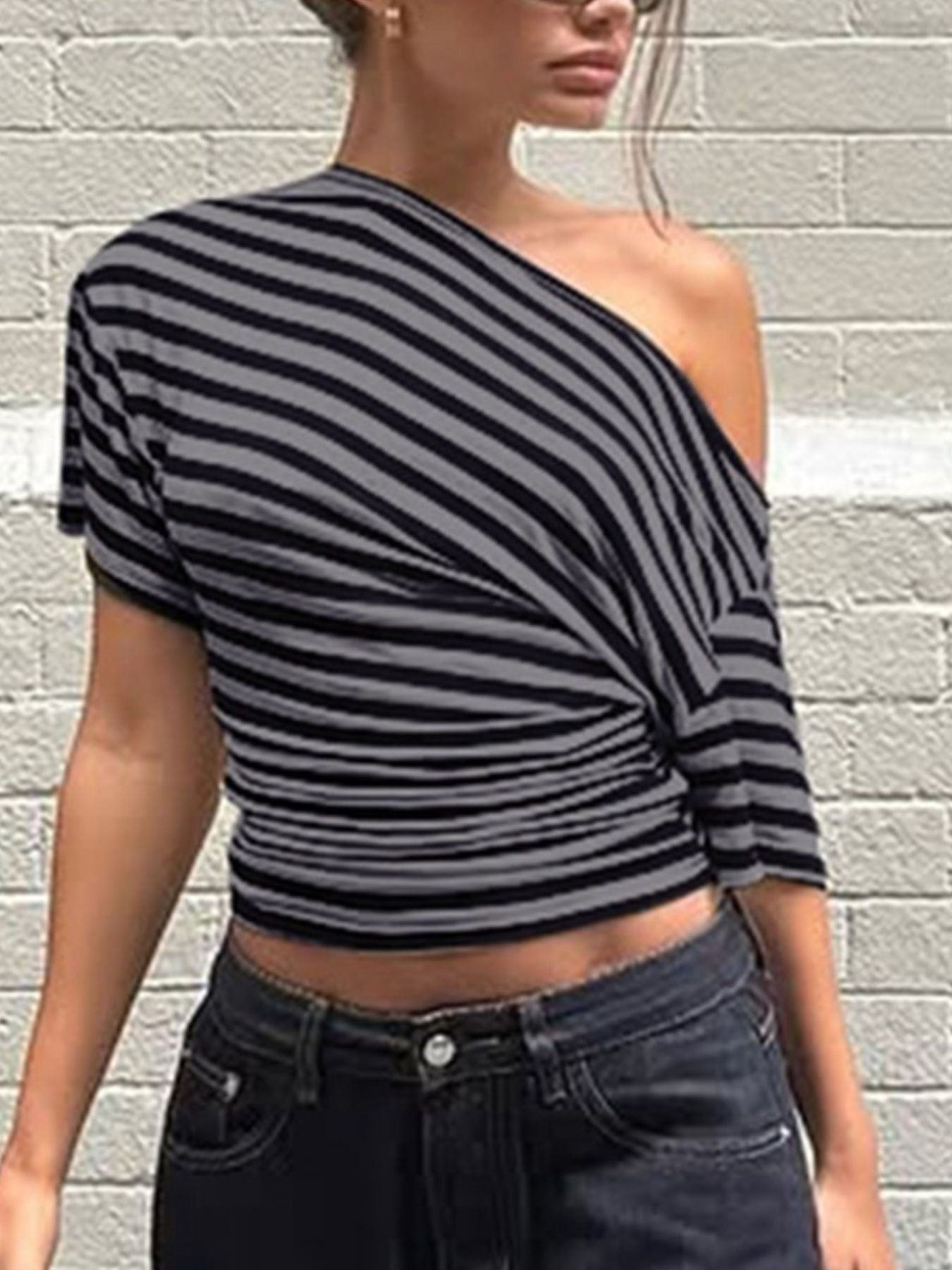 Dark gray and black striped cropped one-shoulder t-shirt with ruched detail.