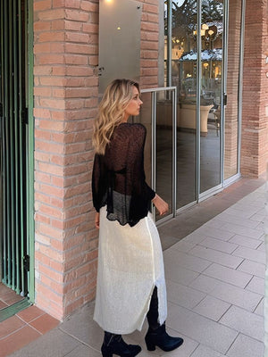 Black textured knit batwing cover-up with sheer sleeves and scalloped hem.