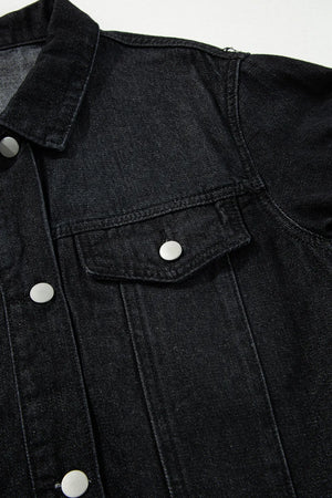 Black denim trucker jacket with silver buttons and chest pocket detail.