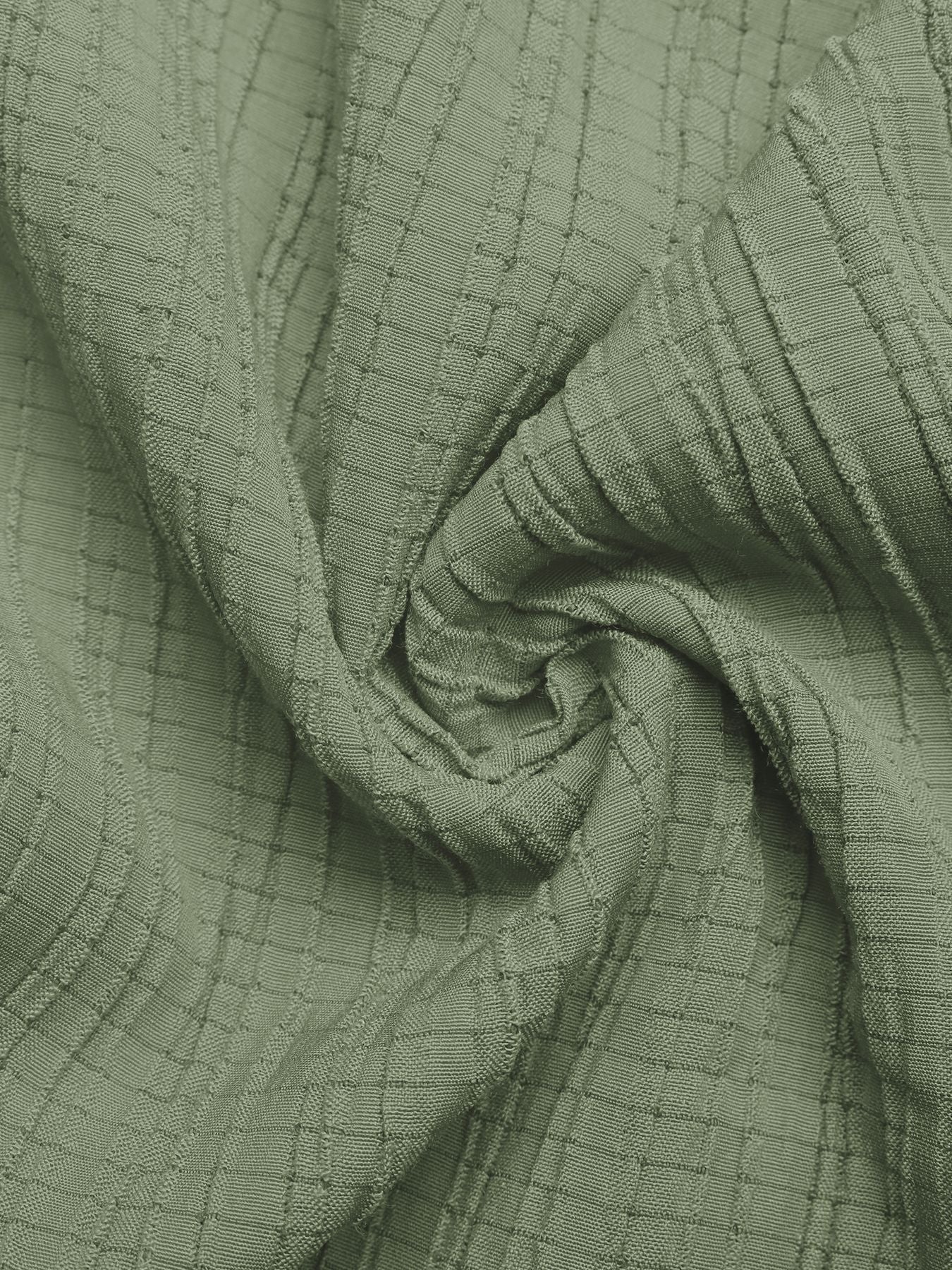 Sage green crinkled texture tie waist wide leg maternity jumpsuit fabric detail.