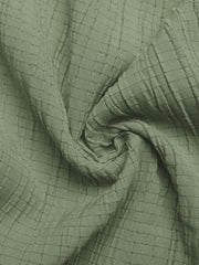 Sage green crinkled texture tie waist wide leg maternity jumpsuit fabric detail.