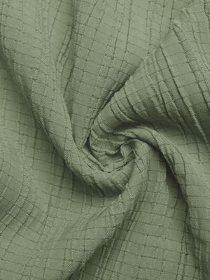 Sage green crinkled texture tie waist wide leg maternity jumpsuit fabric detail.