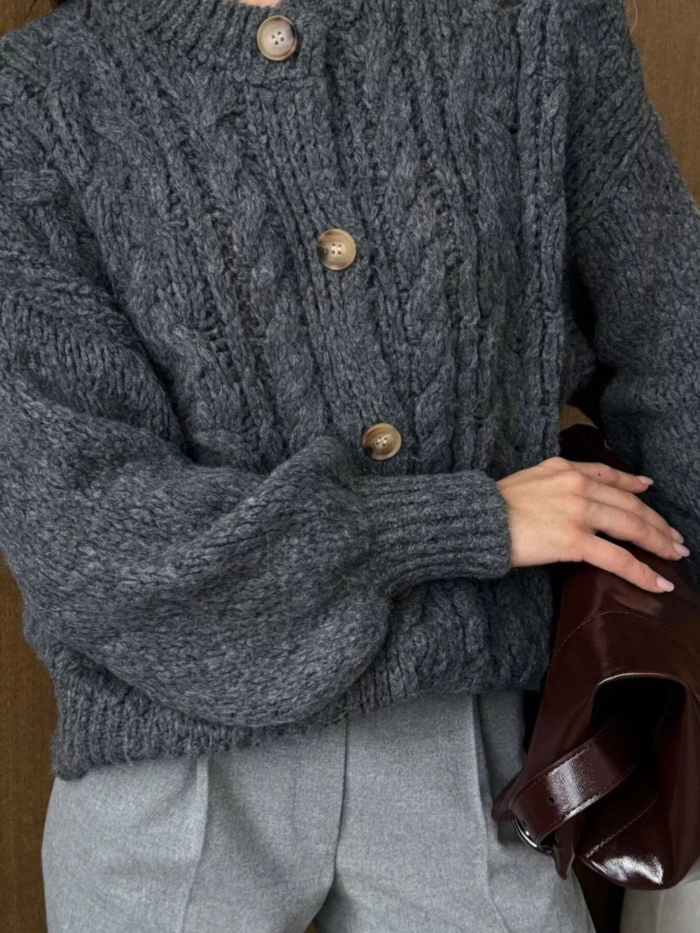 Gray cable-knit button-down cardigan with balloon sleeves and wooden buttons.