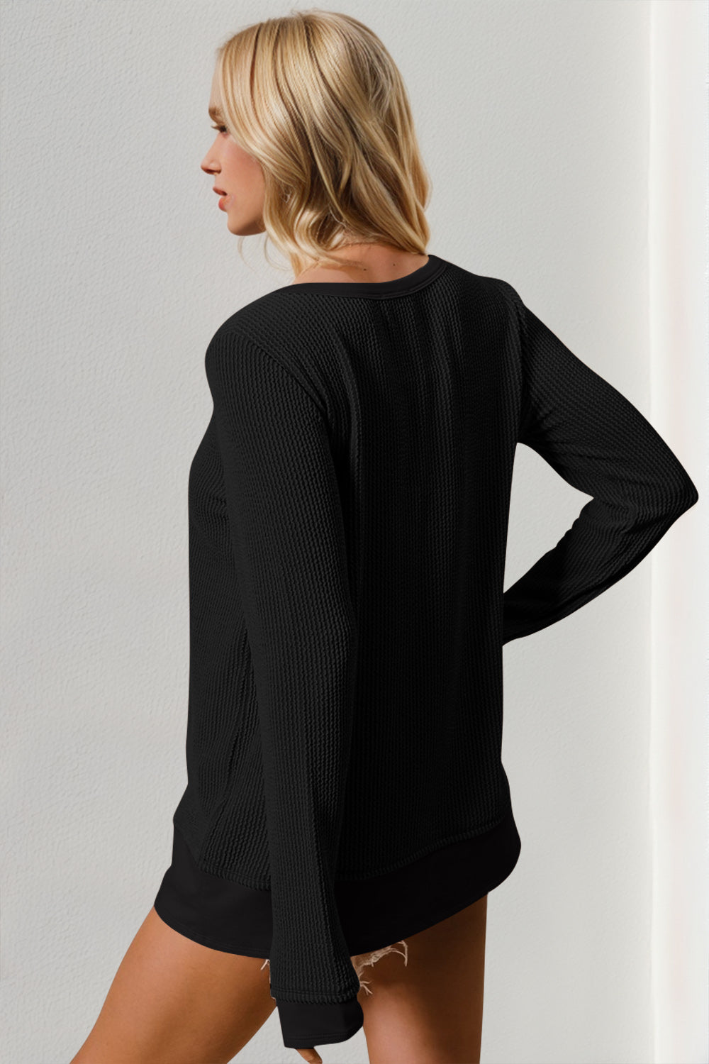 Black textured crew neck thermal top with long sleeves.