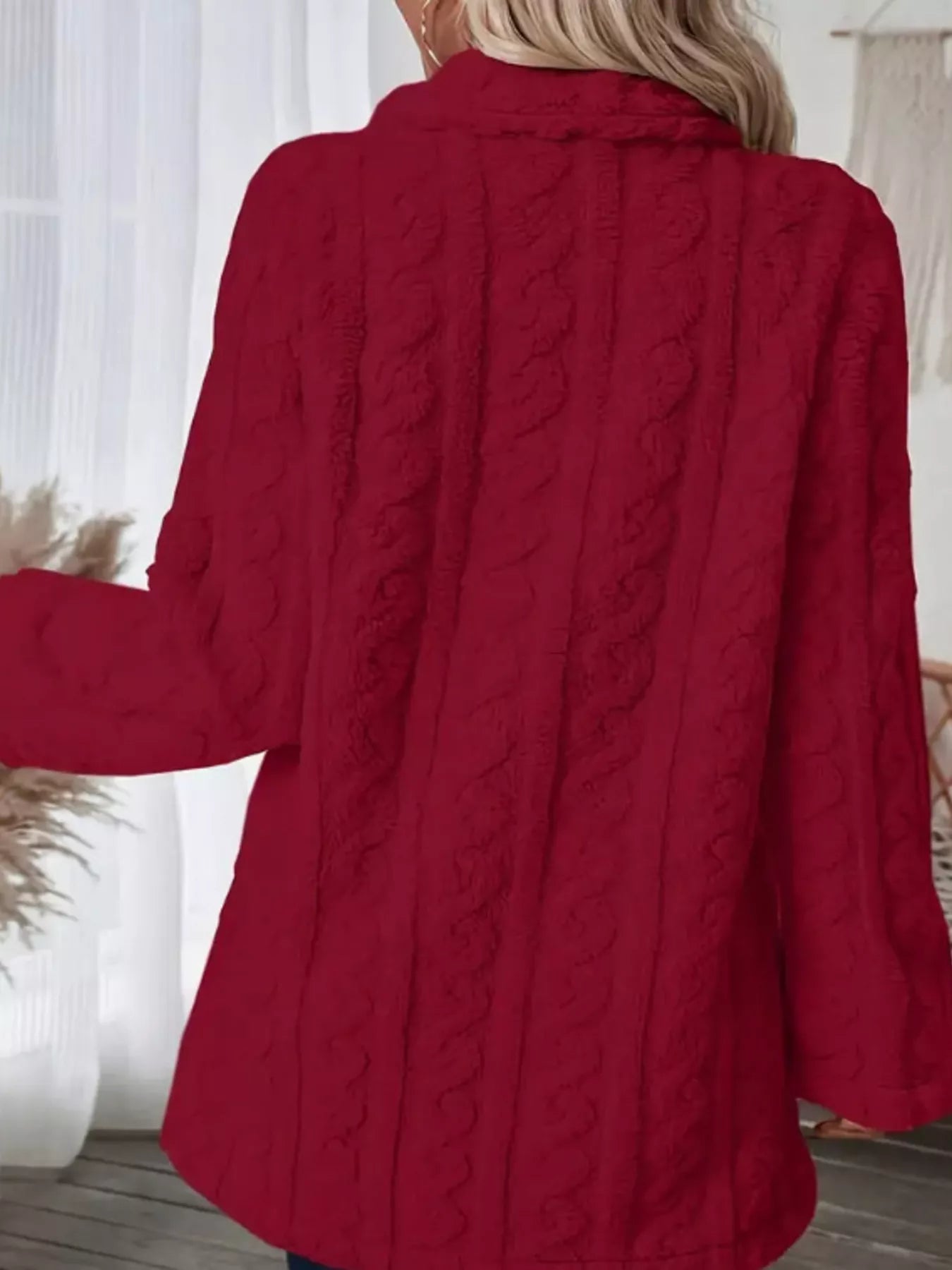 Red faux shearling coat with cable knit texture and a double-breasted style.