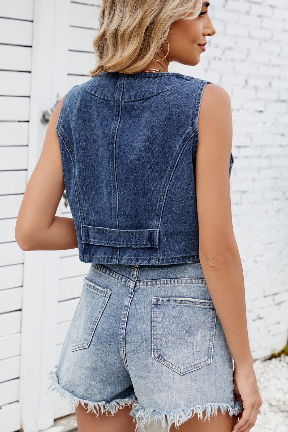 Noir denim cropped vest with button details and a cropped length.