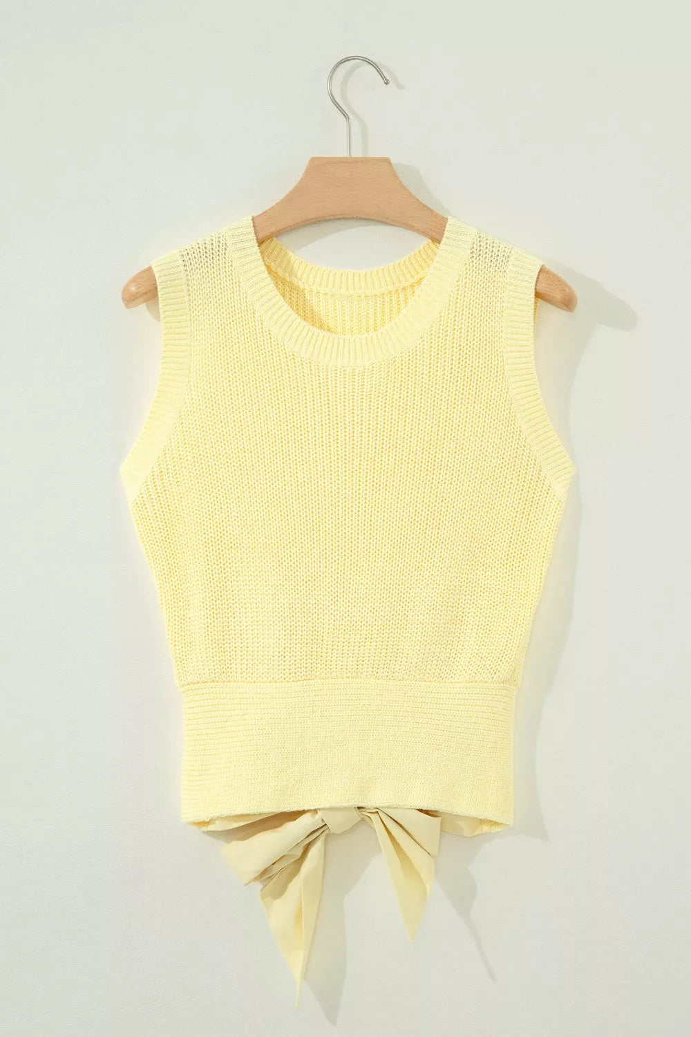 Yellow knit sweater vest with round neck and back tie detail