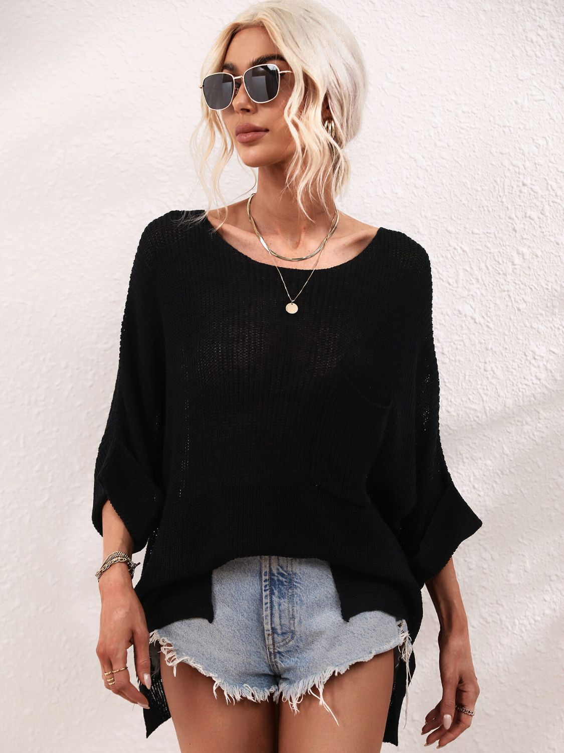 Black relaxed knit tunic top with boat neck, short sleeves, and a chest pocket.