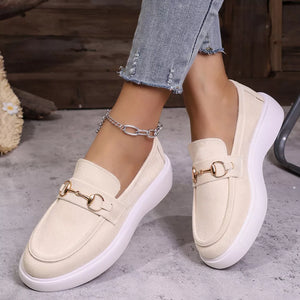 White loafers with gold horse-bit detail and white platform sole.