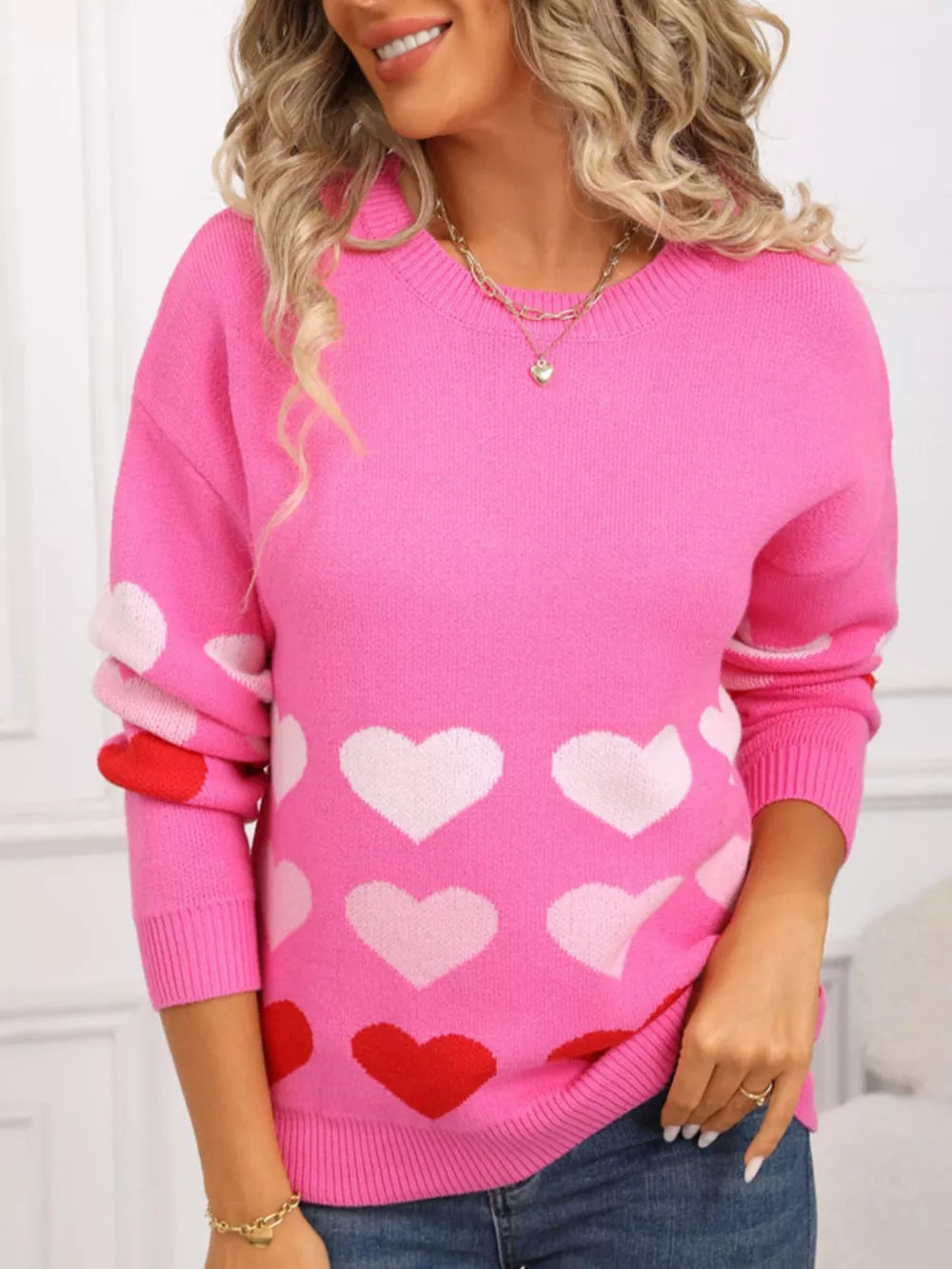 Rose red acrylic crew neck sweater with allover heart print and long sleeves.