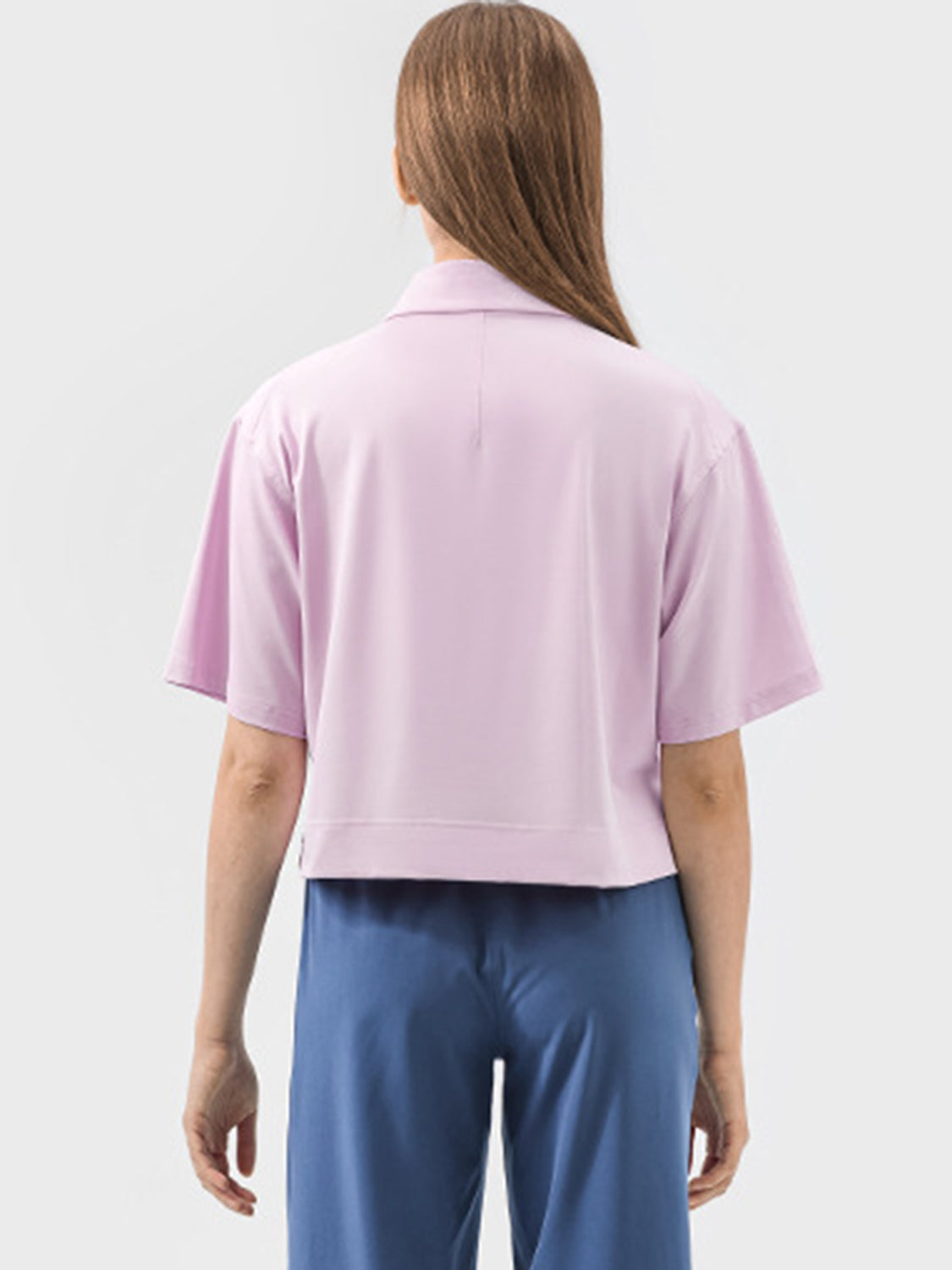 Cropped polo top in blush pink with short sleeves and a classic collar.