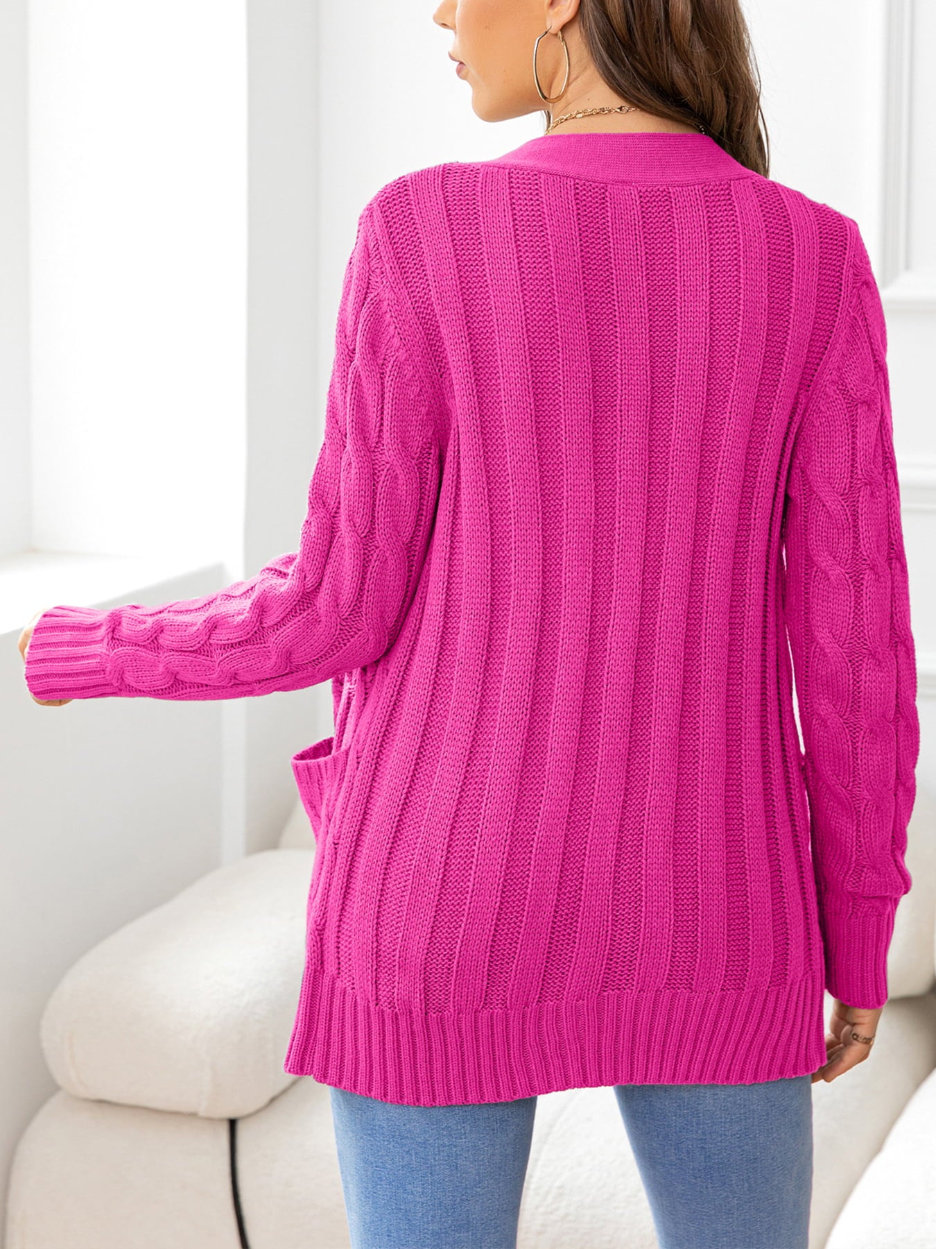 Hot Pink cable-knit cardigan with pockets and ribbed texture.