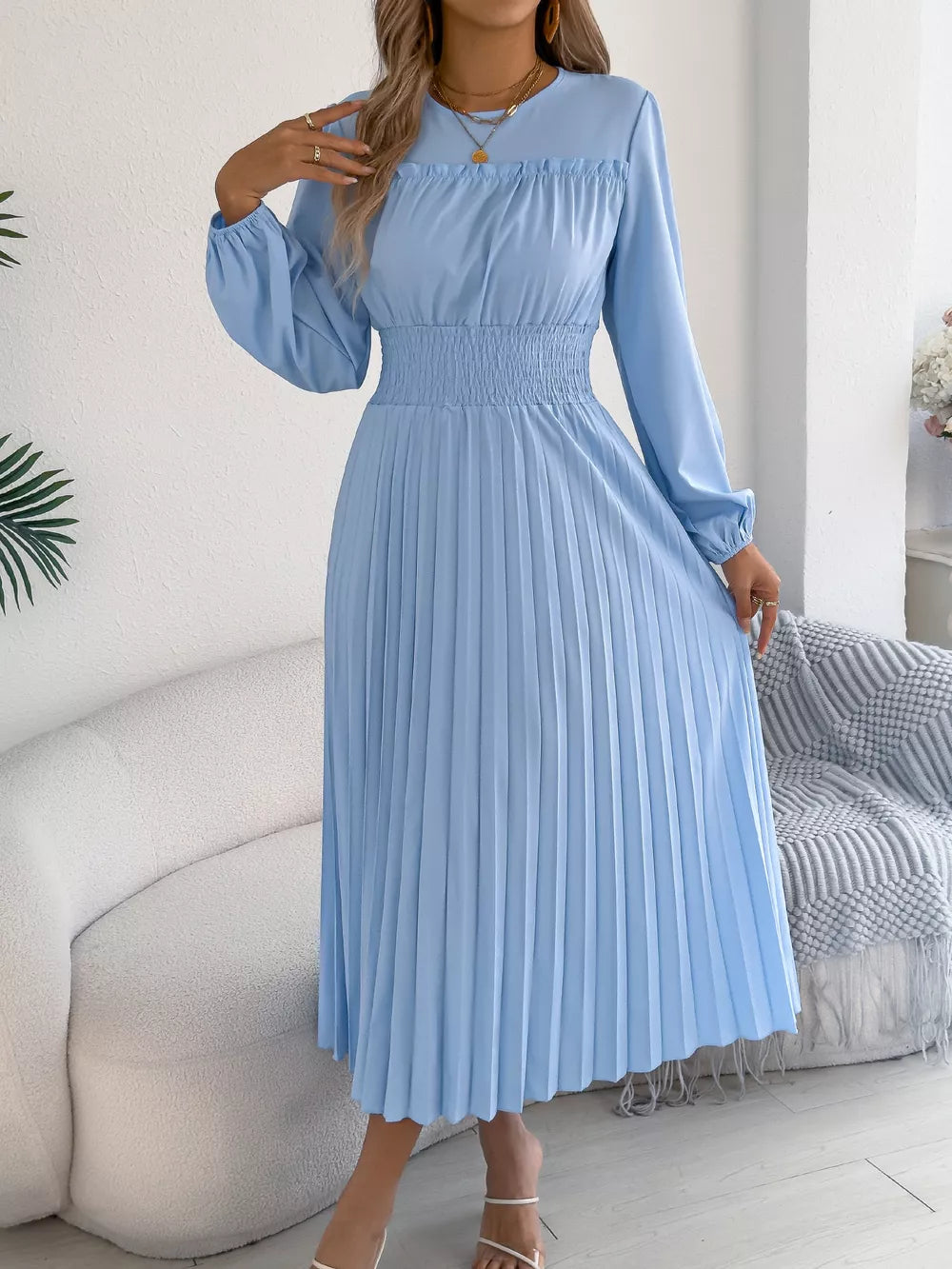 Light blue midi dress with long sleeves, ruffled neckline, and smocked waist.